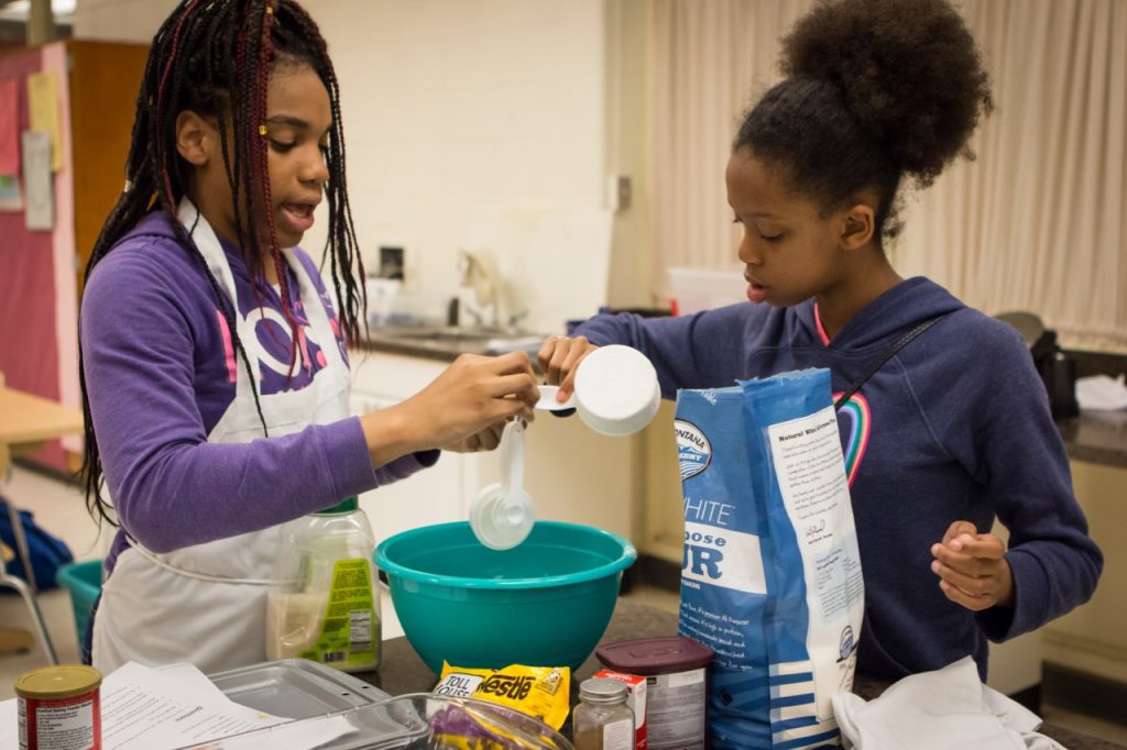 Two RPS Middle Schoolers mixing ingredients into a bowl