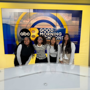 Young women in the MaxPrep program post in the ABC8 newsroom.