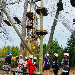 LOCAL Adventures program participants gearing up to enjoy the high ropes course.