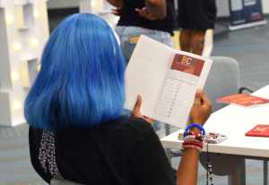 Teen in KR Scholars reading about Historically Black Colleges and Universities on a virtual tour of Virginia State University.