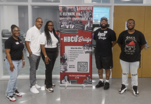 Members of the KR Scholars summer team post in front of a program banner at the Boys & Girls Clubs of Metro Richmond Teen & Community Center.